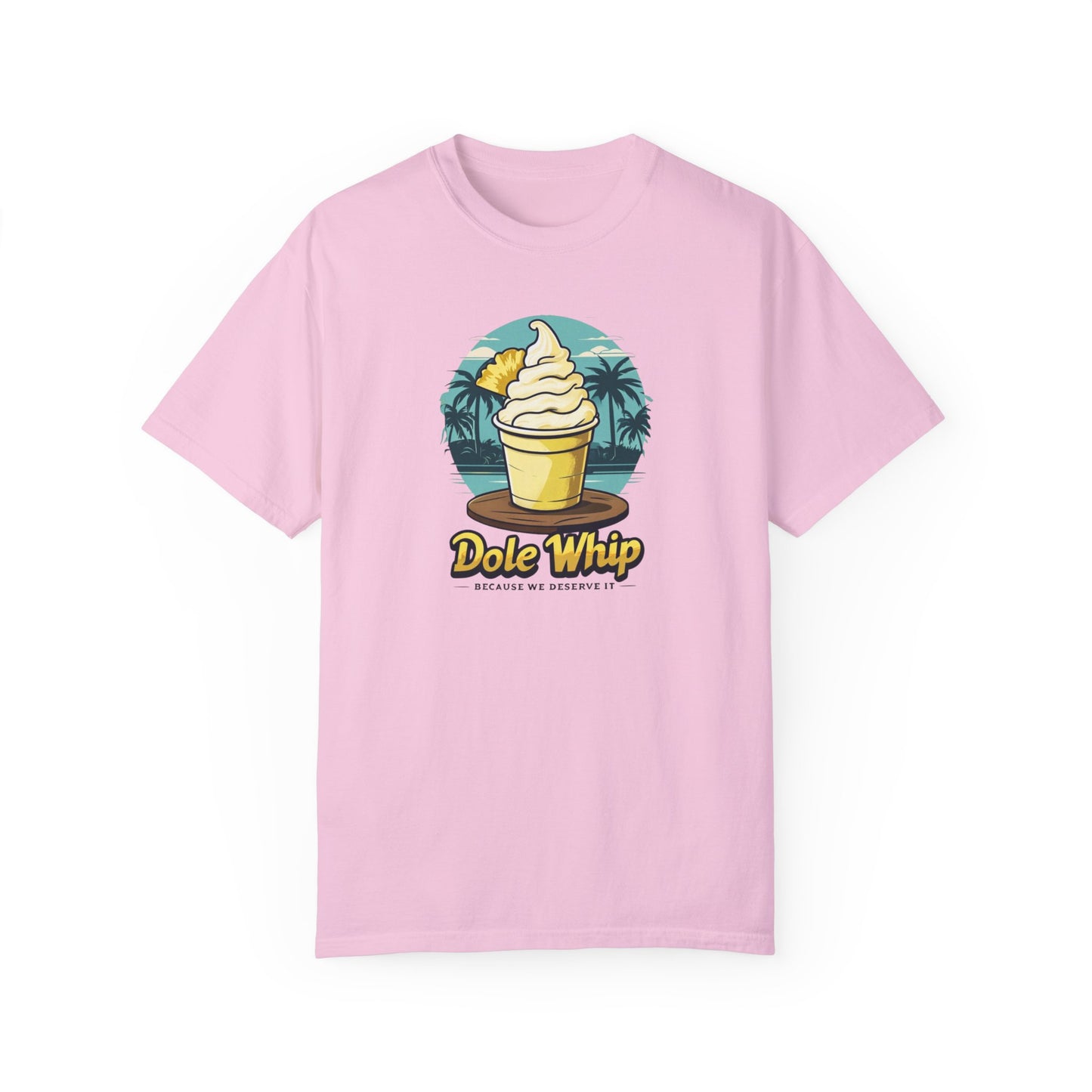 A pink disney t-shirt with a graphic of a Dole Whip ice cream, surrounded by a tropical landscape with palm trees.