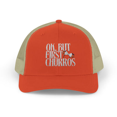 Orange and beige trucker cap with text 'OK, BUT FIRST CHURROS' on a white background