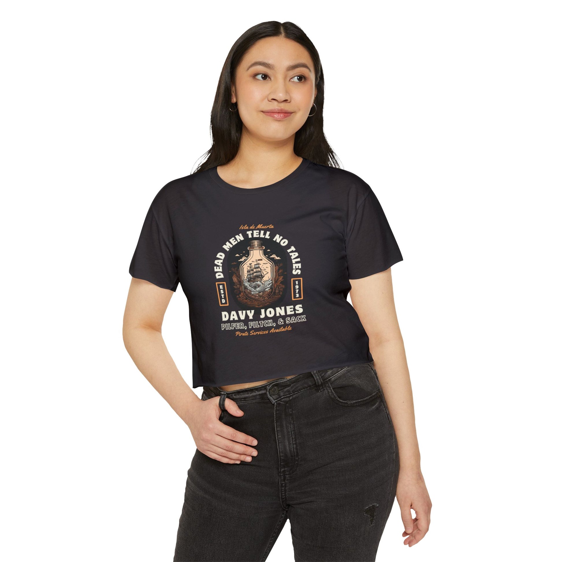 Woman wearing a black t-shirt with a pirates of the Caribbean graphic design on a white background