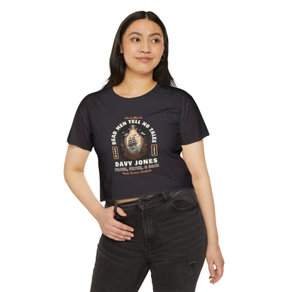 Woman wearing a black t-shirt with a pirates of the Caribbean graphic design on a white background
