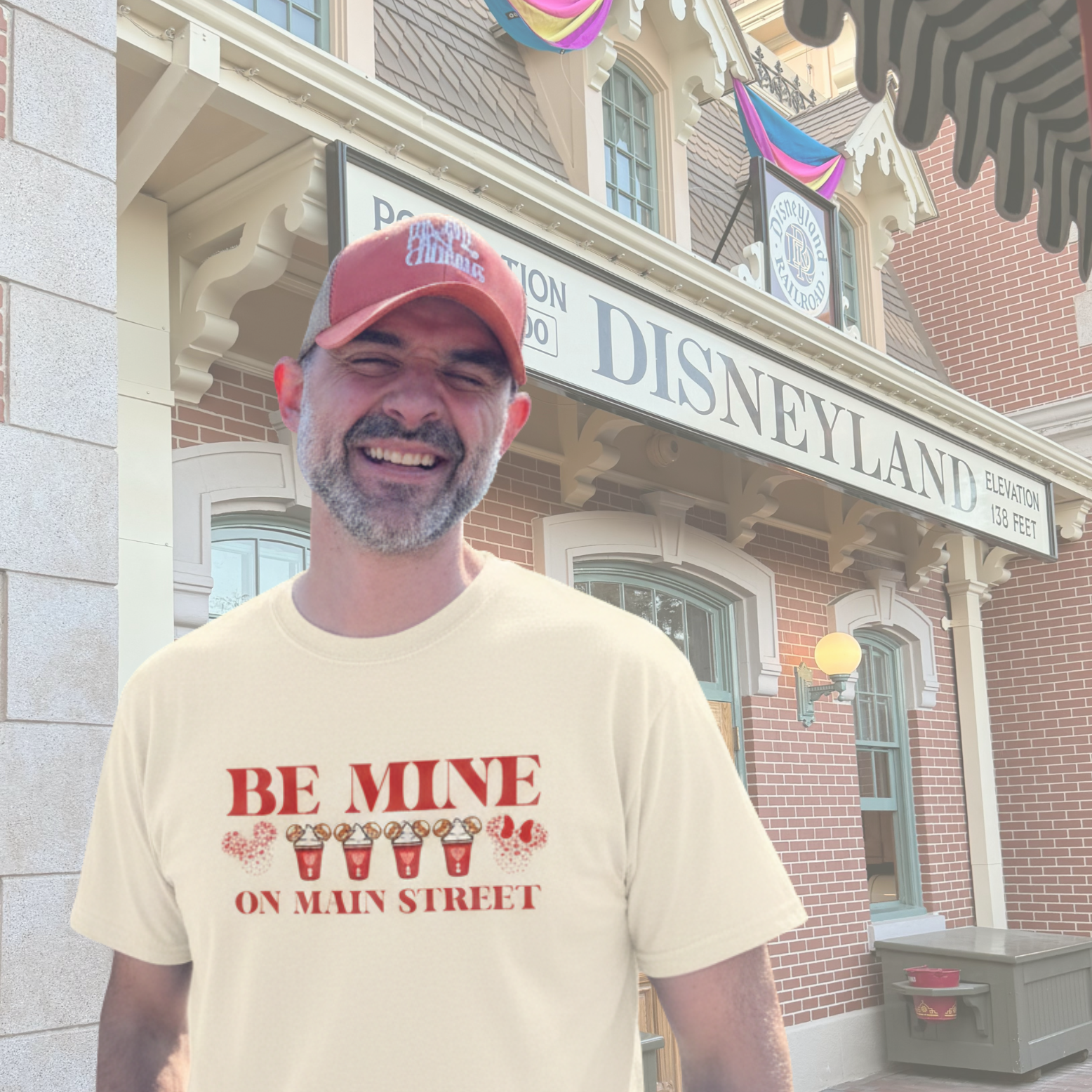 Man wearing a 'Be Mine on Main Street' t-shirt in front of Disneyland entrance.