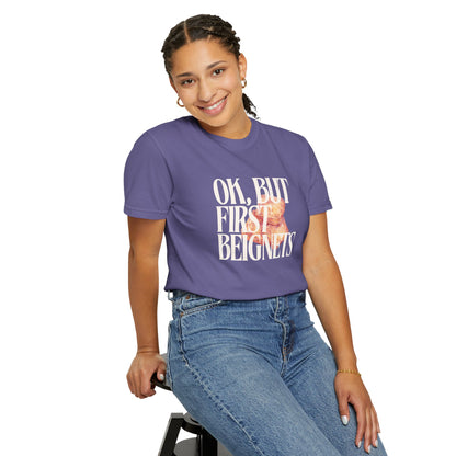 Person wearing a purple t-shirt with text and sitting on a stool against a white background