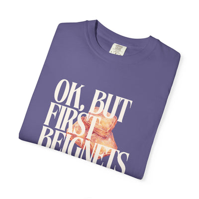 Folded purple t-shirt with graphic and text on a white background