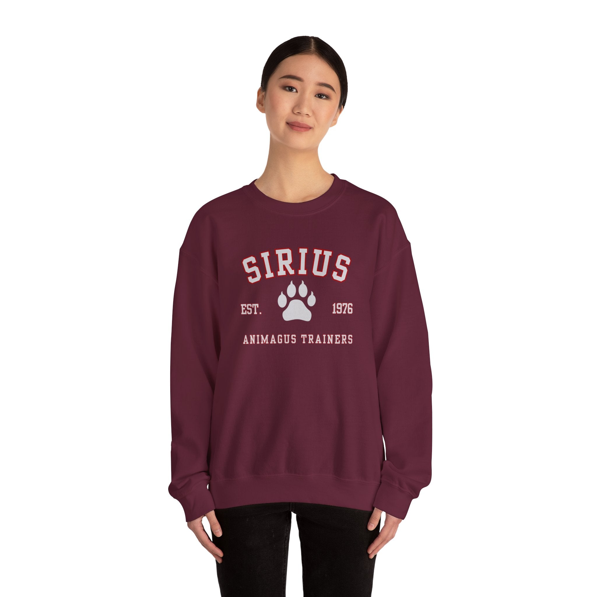 Person wearing a maroon sweatshirt with 'SIRIUS' and paw print design on a white background