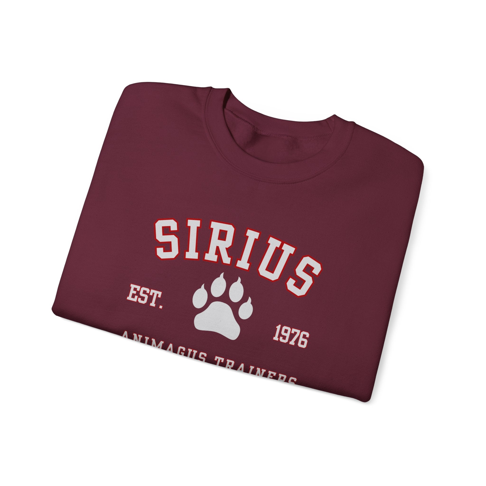 Folded maroon sweatshirt with 'SIRIUS' and paw print design on a white background