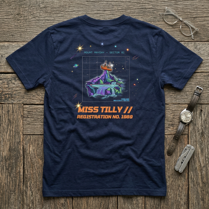 Navy blue t-shirt with space-themed graphic and text on a wooden surface with accessories.