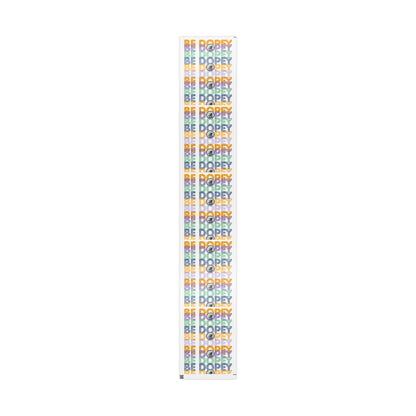 A tall, narrow rectangular banner or flag with a repeating multicolor 'BE DOPEY' text pattern on a white background, shown against a plain white backdrop.