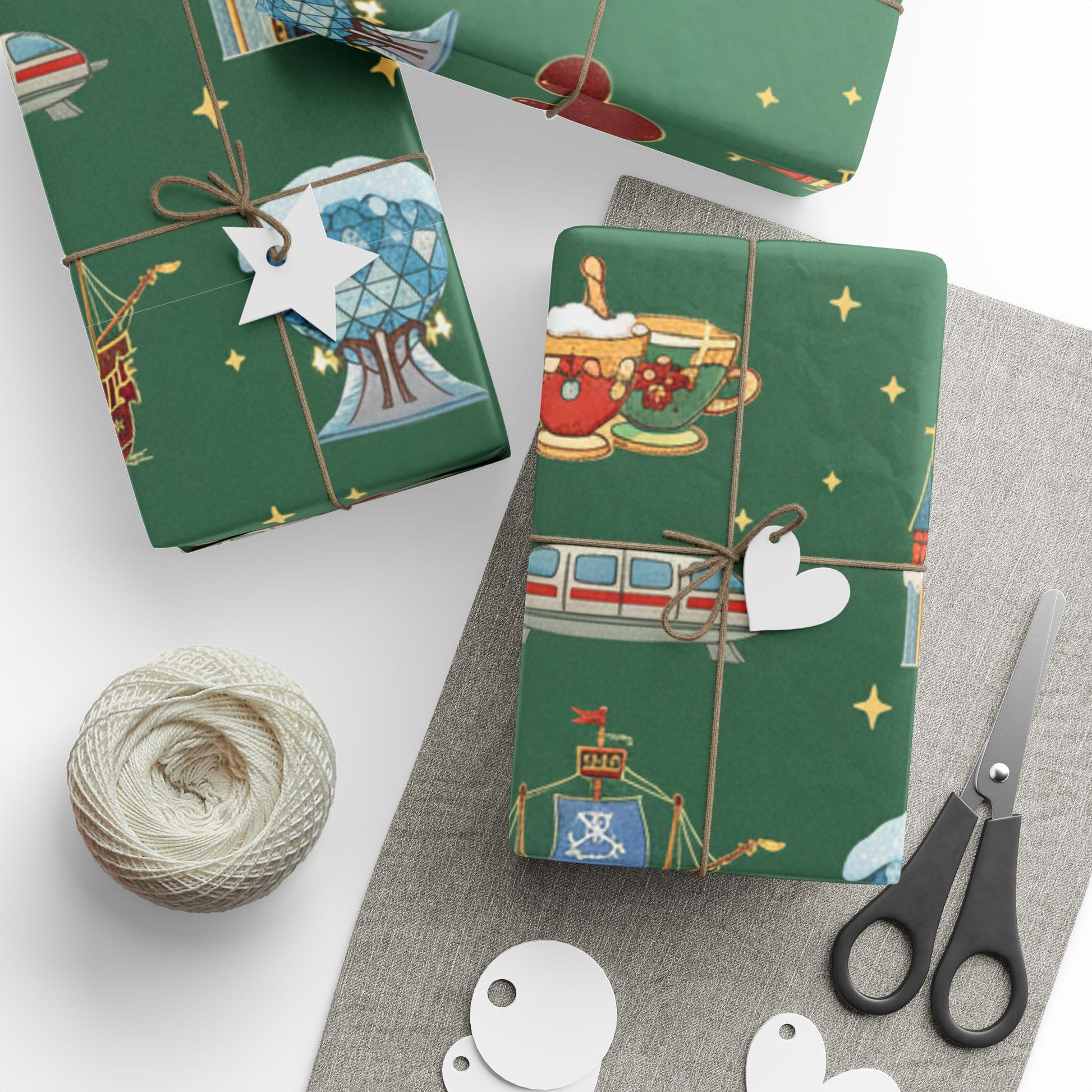 Green gift wrap with festive designs on a white surface with scissors and twine.