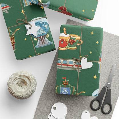 Green gift wrap with festive designs on a white surface with scissors and twine.