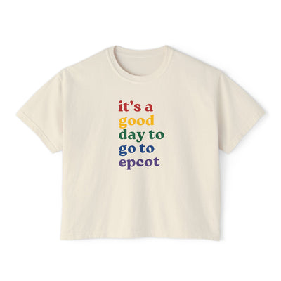 Beige t-shirt with colorful text 'it's a good day to go to epcot' on a white background