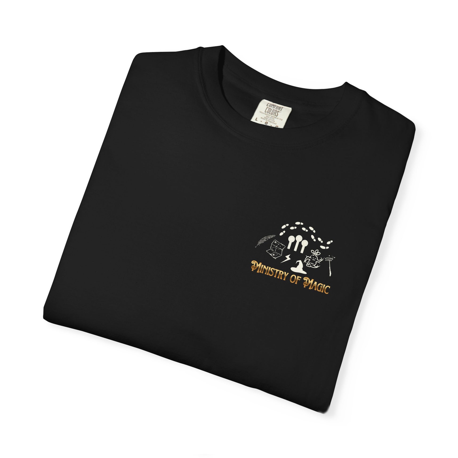 Folded black t-shirt with 'Ministry of Magic' logo on a white background