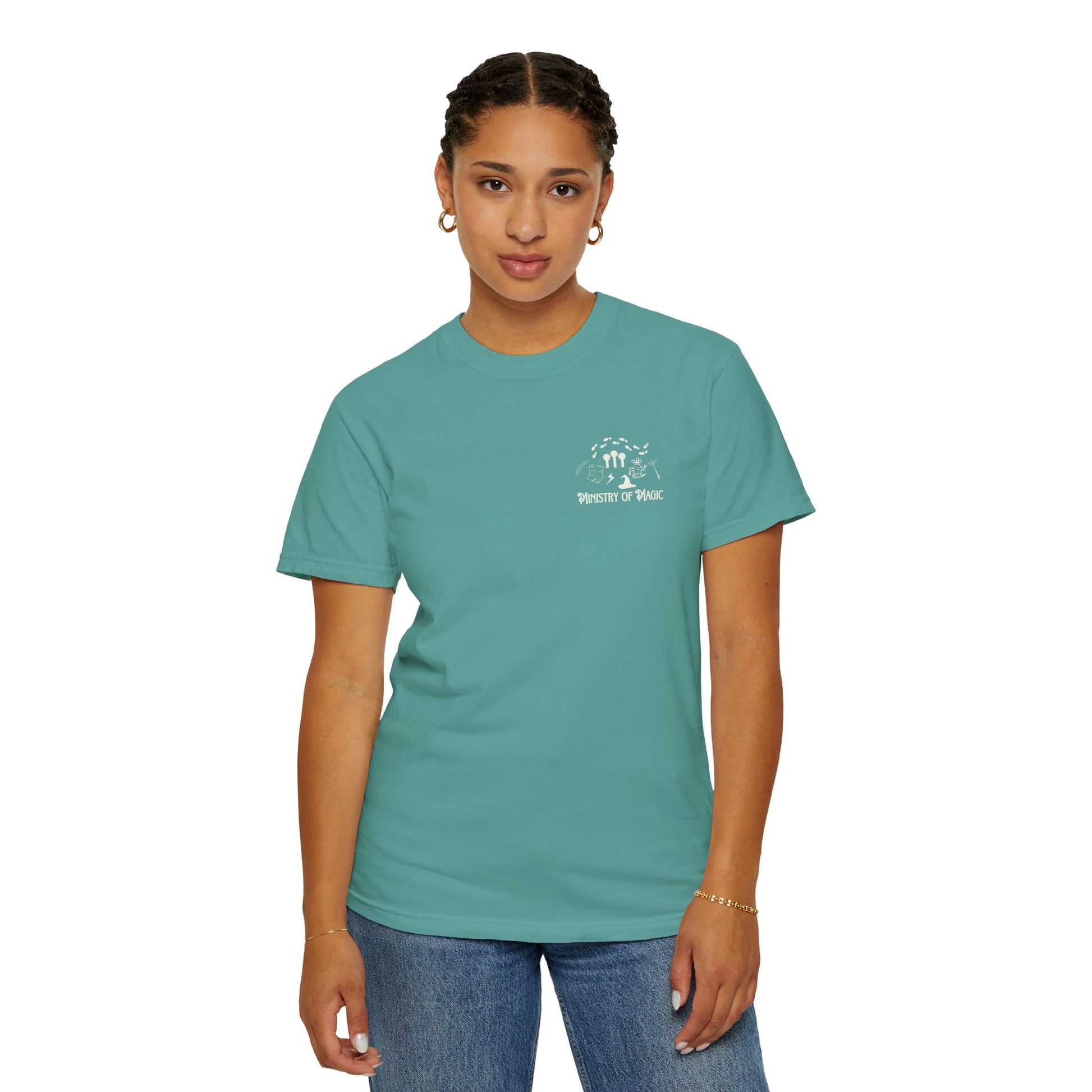 Person wearing a teal t-shirt with a logo on a white background