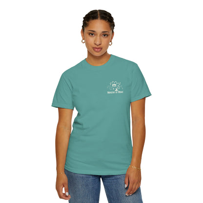 Person wearing a teal t-shirt with a logo on a white background