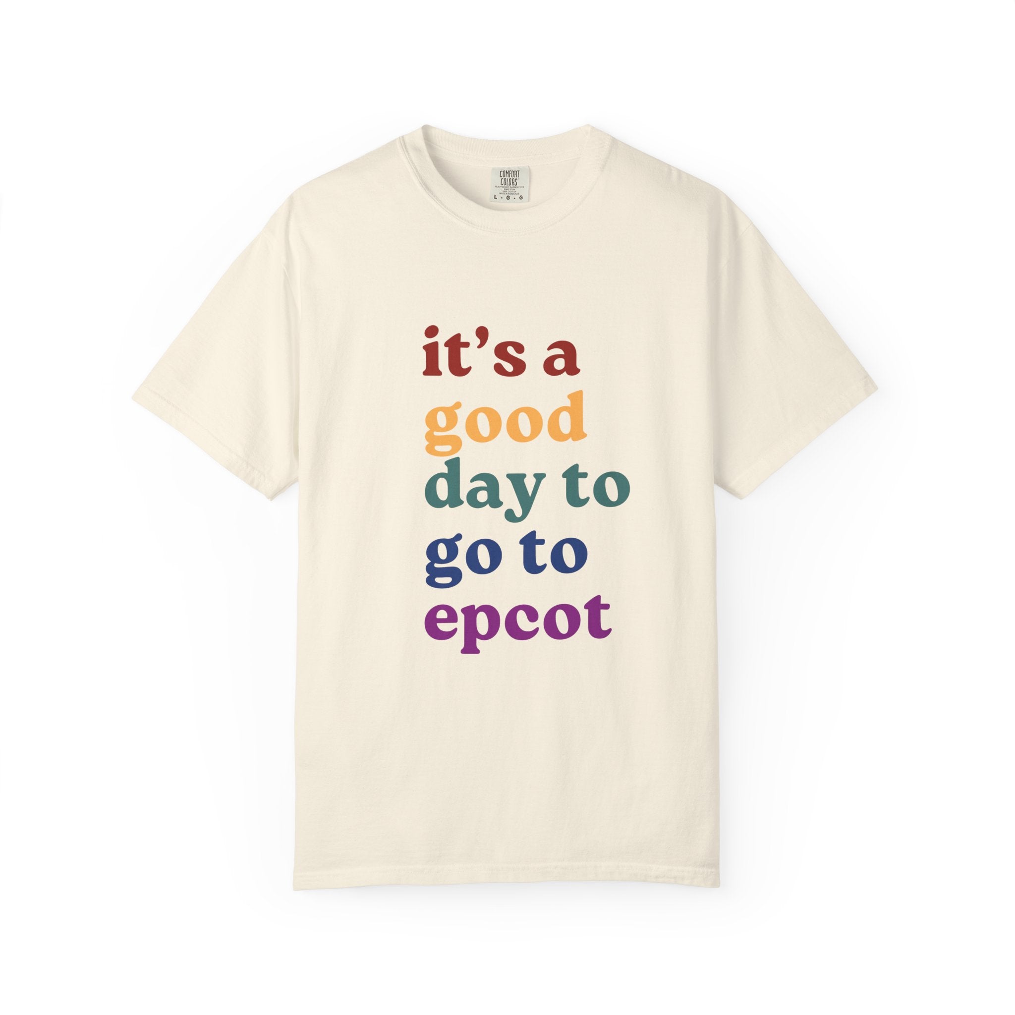 Beige t-shirt with colorful text 'it's a good day to go to epcot' on a white background