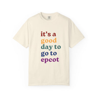 Beige t-shirt with colorful text 'it's a good day to go to epcot' on a white background