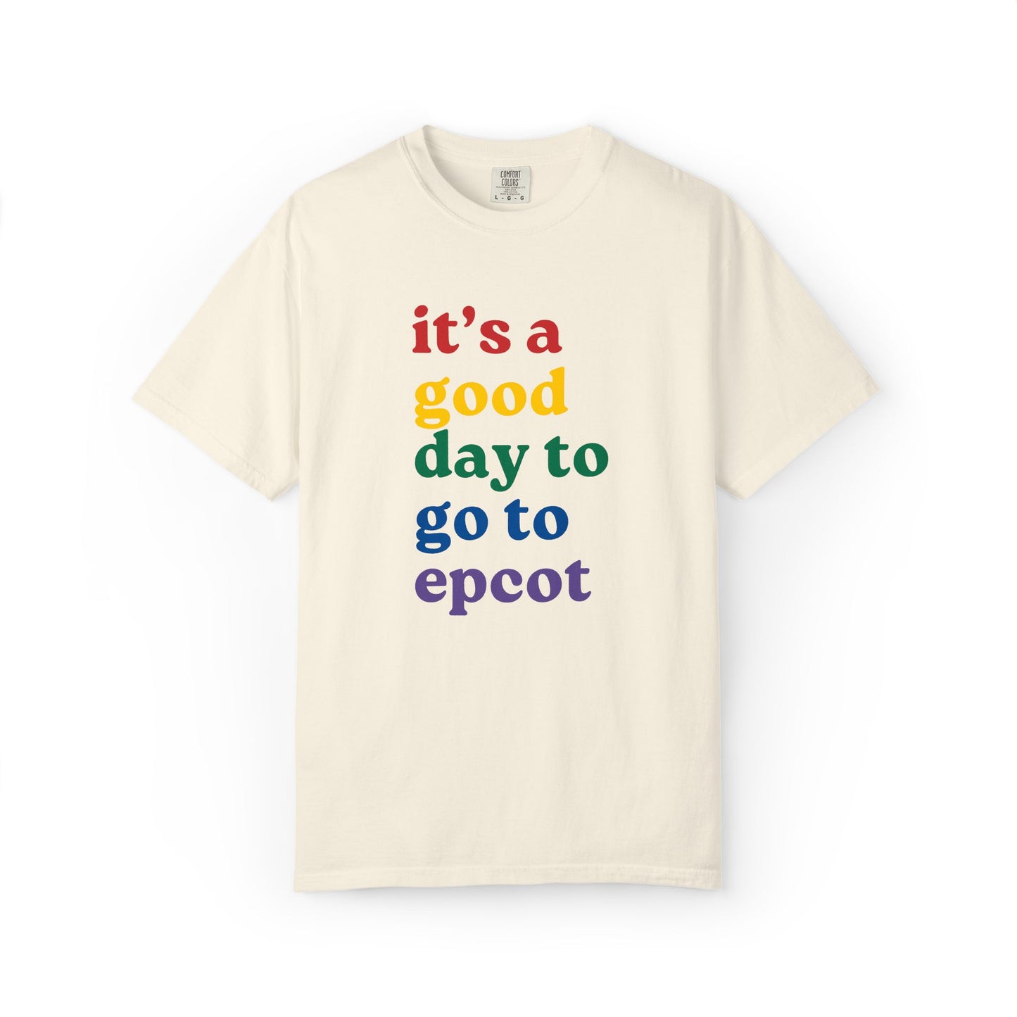Beige t-shirt with colorful text 'it's a good day to go to epcot' on a white background