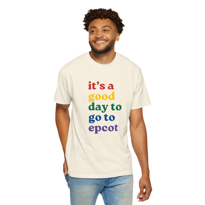 Man wearing a cream t-shirt with colorful text 'it's a good day to go to epcot' on a white background