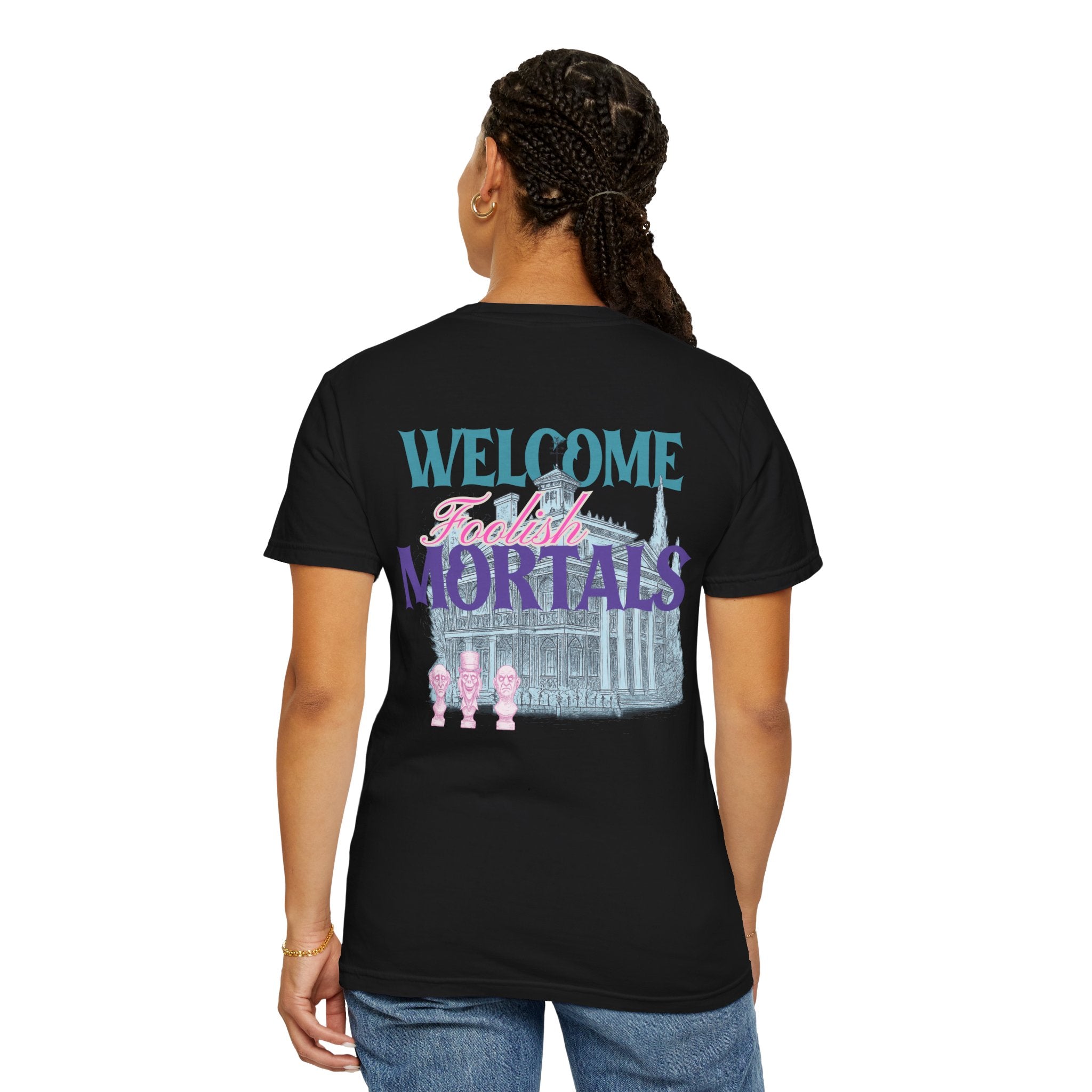 Person wearing a black t-shirt with 'Welcome Foolish Mortals' text and graphics on the back.