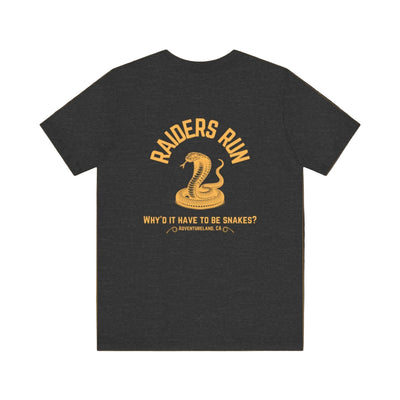 Black indiana jones t-shirt with yellow graphic and text on a brown background