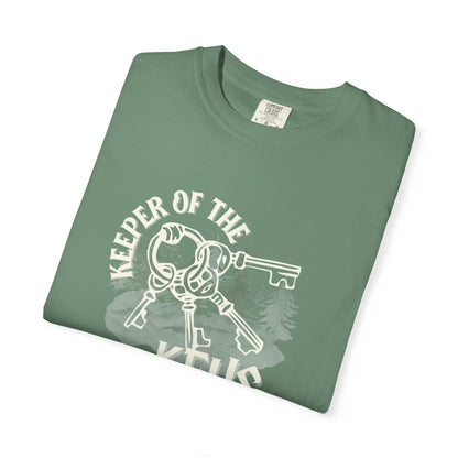 Folded green t-shirt with 'Keeper of the Keys' graphic on a white background