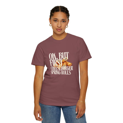 Person wearing a maroon t-shirt with text and graphic design on a white background
