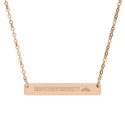 Rose gold necklace with 'ROPE DROP ROYALTY' engraving on a white background