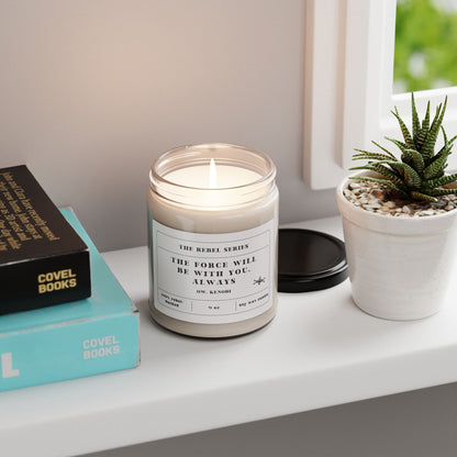 Candle with a quote on a shelf next to books and a plant