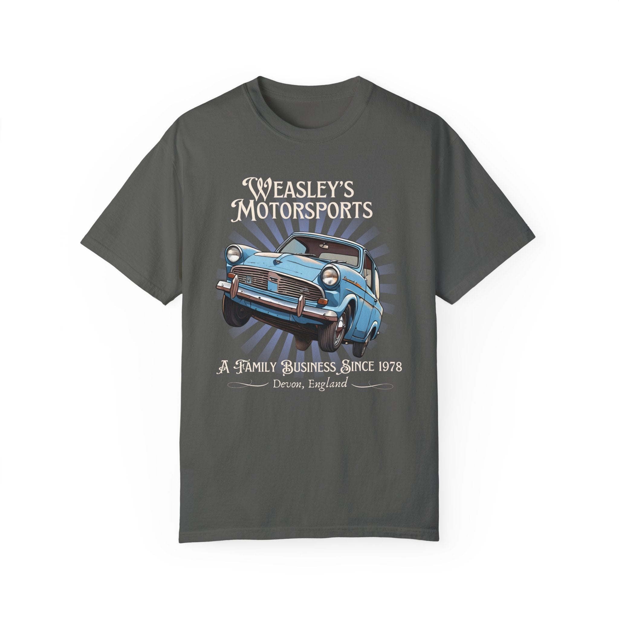 A gray t-shirt featuring a graphic of the flying Ford Anglia car with the text 'Weasley's Motorsports A Family Business Since 1978' on the front.